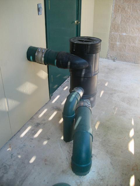 WISY2.JPG - WISY vortex filter. This device consists of a vertical cylindrical body with a tangentially positioned 6" inflow pipe near the top, a 4" outflow pipe near the bottom, and a 6" wastewater discharge pipe below that. January 19, 2010.