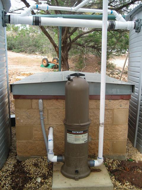 CirculatingFilter.JPG - The circulating filter is an ordinary 20 micron swimming pool cartridge assembly. Water is pumped from the tank supply pipes in the pump house, through the filter, and back into the top of each tank through the fitting on the overflow equalizing pipe.  January 19, 2010.
